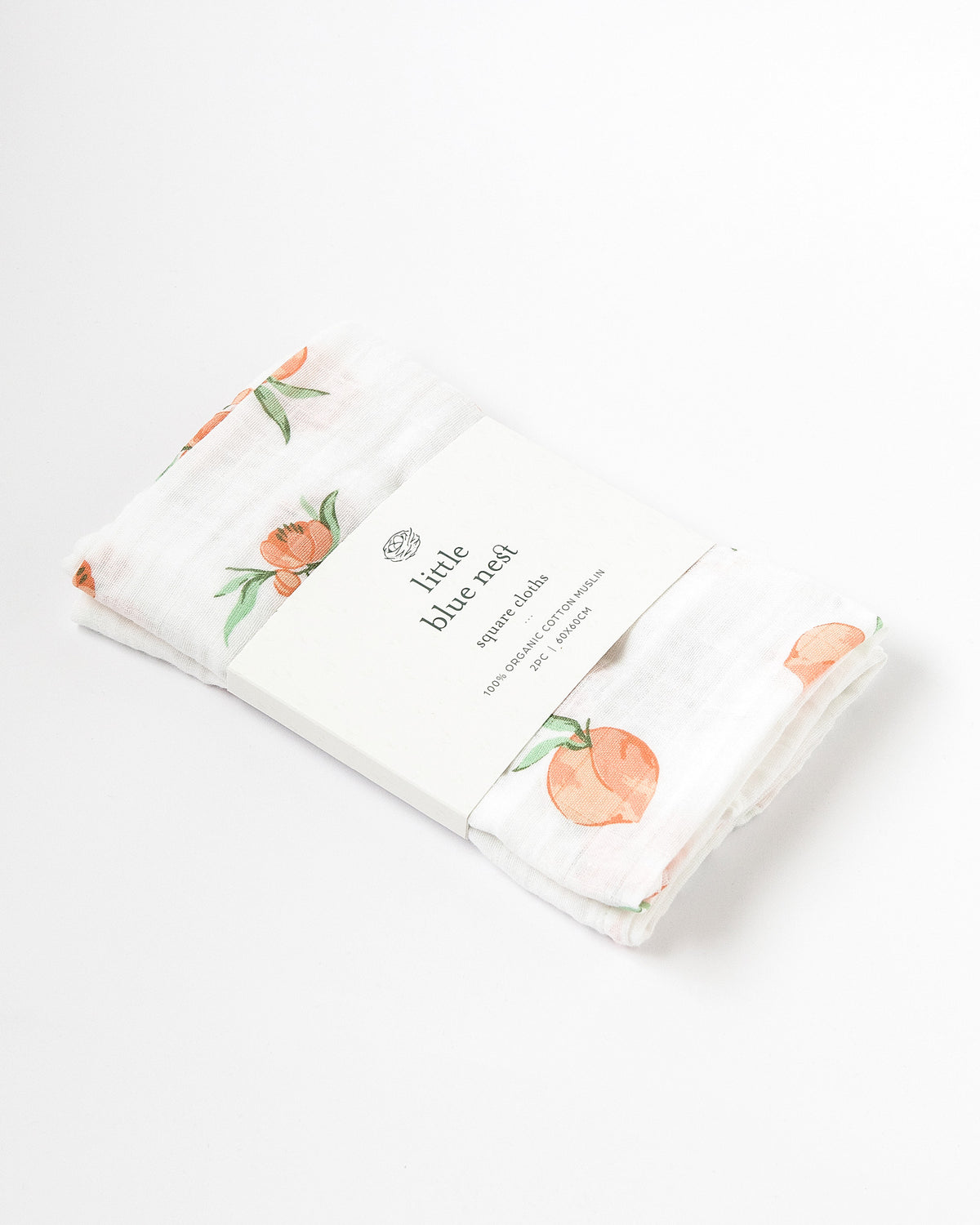Organic cotton muslin square cloths with peach pattern in Little Blue Nest Packaging