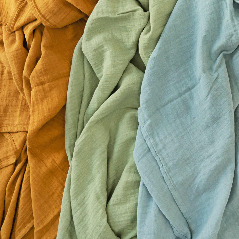 3 solid colours of organic cotton muslins - orange, green and blue