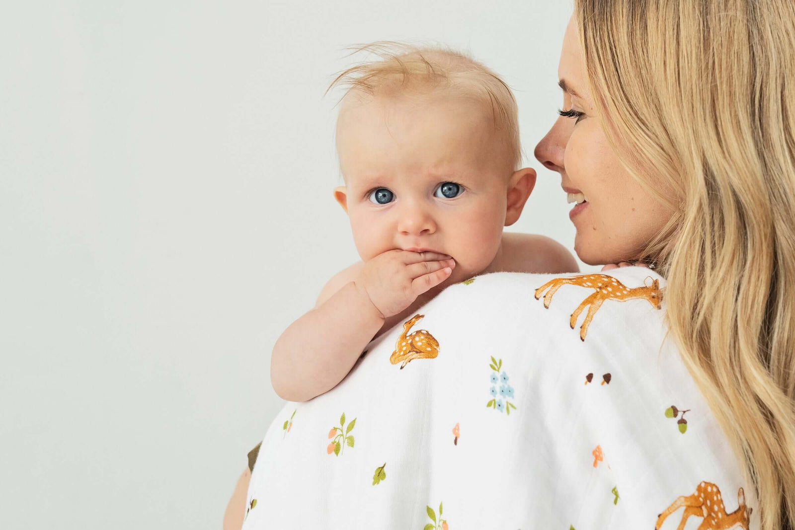 Mother and child covered with cotton blanket