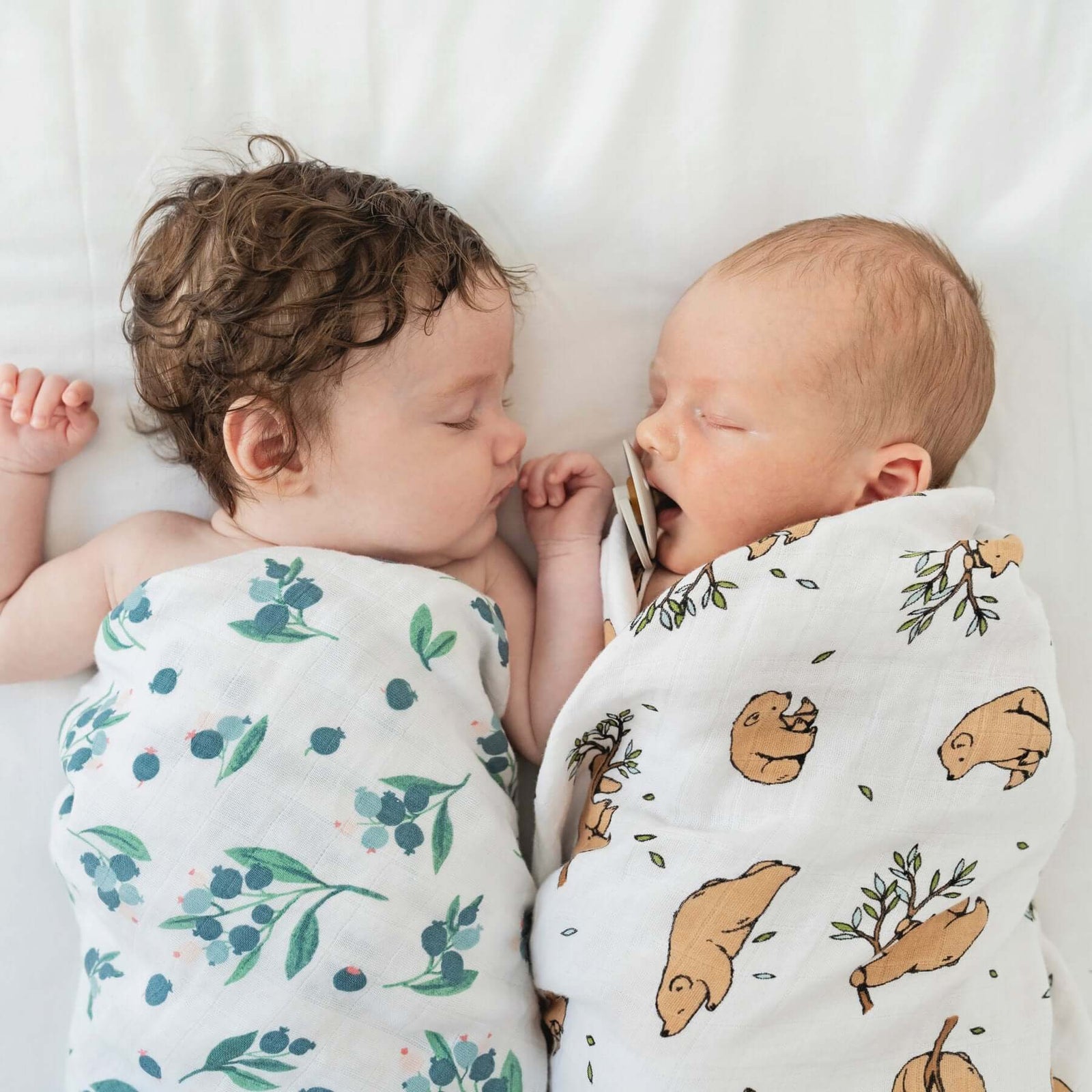 Two swaddled sleeping babies