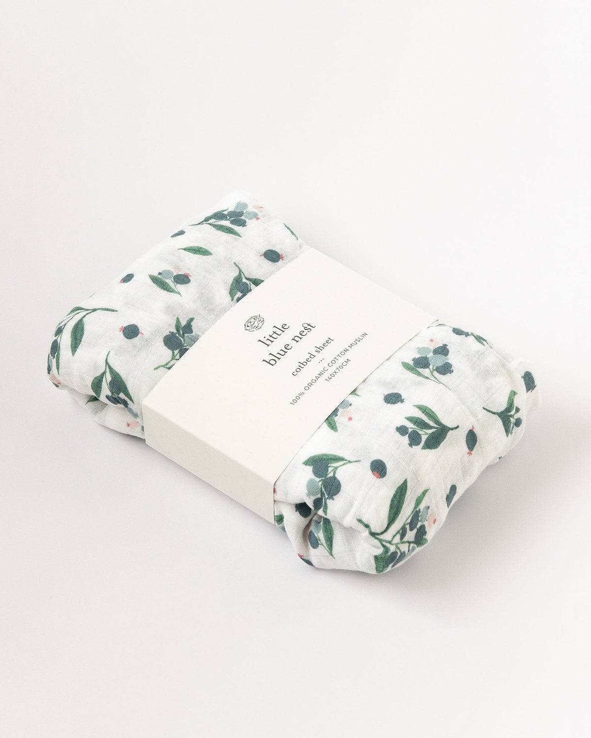 Organic cotton muslin fitted cotbed sheet with blueberry pattern 140cm x 70cm in Little Blue Nest Packaging