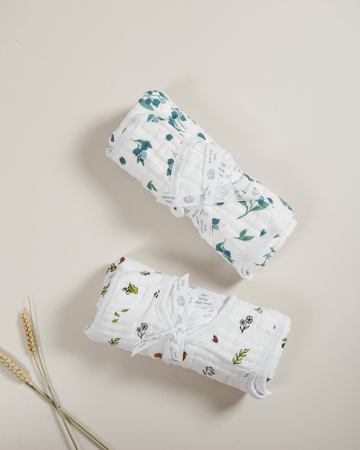 Organic cotton muslin baby sleeping bag 1.5 tog with blueberry pattern rolled up with ribbon