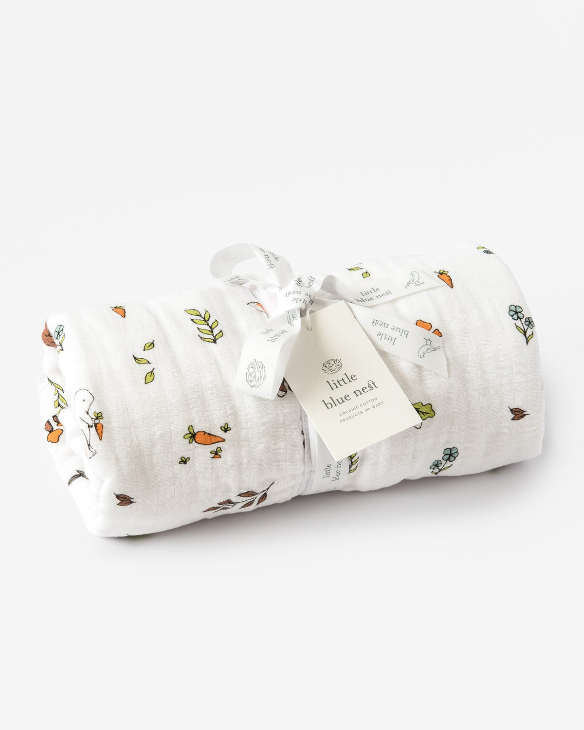 Organic cotton muslin baby sleeping bag 1.5 tog with woodland pattern rolled up in Little Blue Nest packaging
